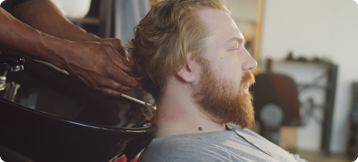 Stylist cutting customer's hair